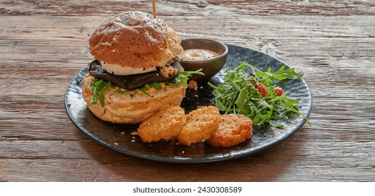 Plate with Vegetarian burger and rosti on textured wooden table - Powered by Shutterstock