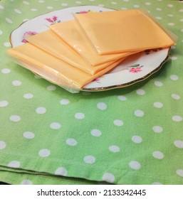 Plate Of Wrapped Cheese Slices. 