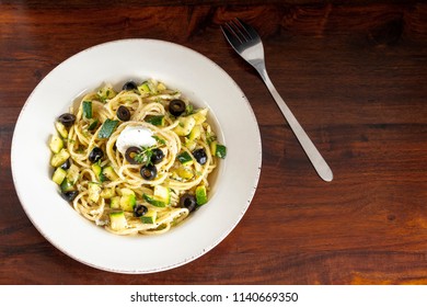 Plate Of Zucchini, Goat Cheese And Black Olives Pasta 