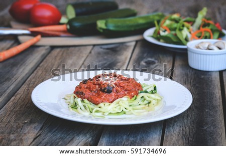 Plate of Zucchini Spaghetti With Veggies in Background