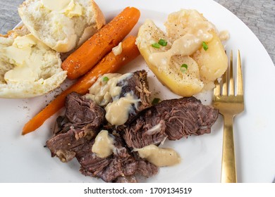 Plated Dinner Of Pot Roast, Carrots, Potatoes, And Gravy