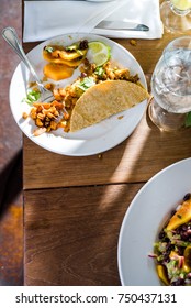 A Plated Filled With A Breakfast Taco. Mango, Avacado, Lime And Diced Sweet Potatoes.