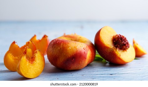 platerina a stone fruit has the characteristics of a nectarine and a paraguayan on a blue table top. - Shutterstock ID 2120000819