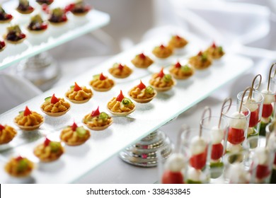 Plates With Assorted Finger Food Snacks On An Event Party Or Dinner