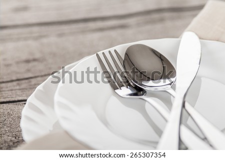 Plates and cutlery on a wooden table