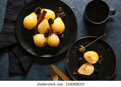 Plates with delicious poached pears, prunes and cup of coffee on dark background