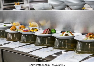 Plates Of Food Being Prepared In A Commercial Kitchen