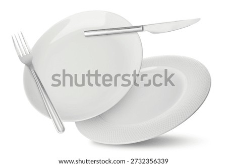 Plates, fork and knife falling on white background