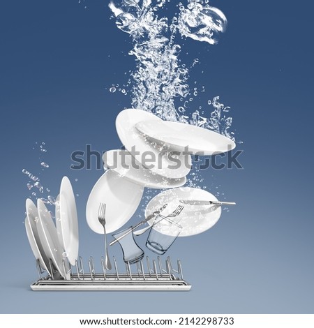 
Plates and glasses, forks, knives floating in the water in the dishwasher, blue background