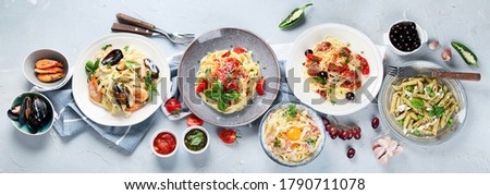 Plates of pastas with different kinds of sauces, top view.  Italian food concept. Panorama, banner
