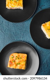 Plates With Pieces Of Mashed Potato Casserole On Dark Background