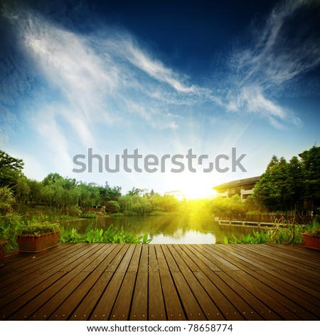 platform beside lake with sunset in park