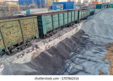 A platform for unloading inert materials from freight railway cars. Crushed stone unloading. Aerial view. Precast concrete plant.