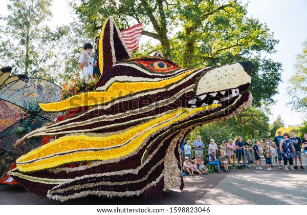 Platform with wolf head made from flowers.\
Compositions in flower parade Bloemencorso. Beautiful colorful\
figures compositions from flowers. Theme \