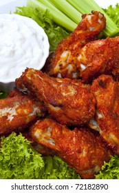 Platter Of Buffalo Wings With A Blue Cheese Dipping Sauce And Celery Sticks.  Hot And Spicy!