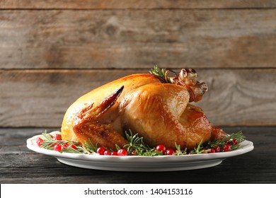 Platter Of Cooked Turkey With Garnish On Wooden Table