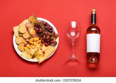 Platter with crunchy crackers and cheese with bottle of wine on color background - Powered by Shutterstock