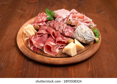 Platter Of Delicious Italian Ham, Salami And Cheese On Wooden Table