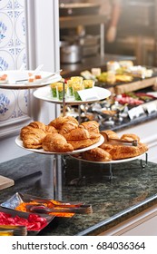 A platter of freshly baked crispy croissants at breakfast buffet in a hotel