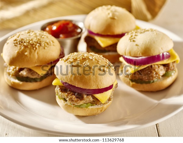 platter of mini\
burger sliders with\
ketchup,