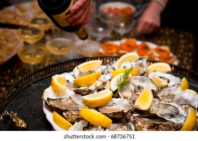 Platter of Oysters and serving champagne