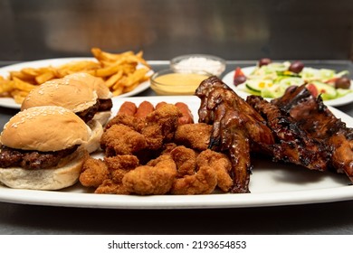 Platter With Sliders, Chicken, Ribs, Wings, Fries And Salad 