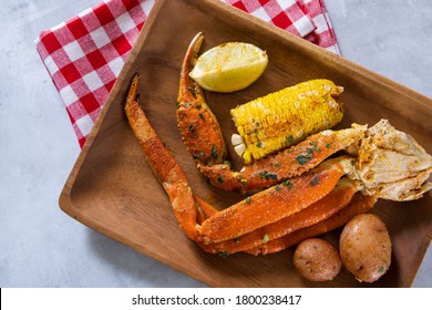 Platter Of Southern Garlic Crabs Seafood Boil With Alaskan Crab Legs, Small New Red Potatoes, Corn On The Cob, And Shrimp