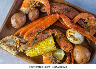 Platter Of Southern Garlic Crabs Seafood Boil With Alaskan Crab Legs, Small New Red Potatoes, Corn On The Cob, And Shrimp