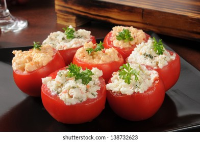A platter of tomatoes stuffed with crab spinach dip