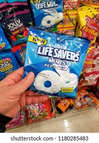 PLATTSBURGH, USA - SEPTEMBER 10, 2018: A Man Holding Life Savers Mints Pack. Life Savers Is An American Brand Of Ring-shaped Hard Candy.