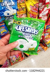 PLATTSBURGH, USA - SEPTEMBER 10, 2018: A Man Holding Life Savers Pack Mints. Life Savers Is An American Brand Of Ring-shaped Hard Candy.