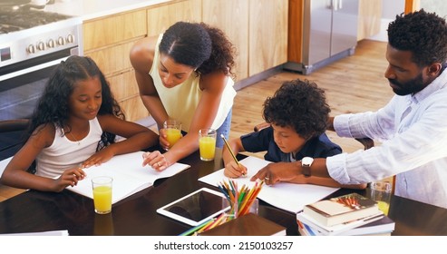 Play An Active Role In Your Childs Homework. Cropped Shot Of Parents Helping Their Two Children With Their Schoolwork At Home.