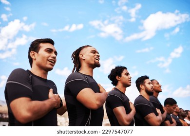 Play with all your heart. a team of young rugby players singing the national anthem before a game. - Powered by Shutterstock