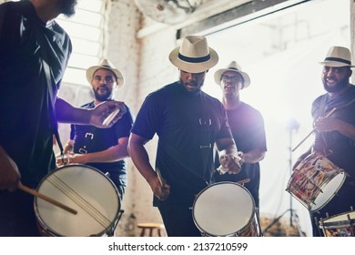 Play it to the beat. Shot of a group of musical performers playing drums together. - Shutterstock ID 2137210599