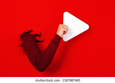 Play Button In Hand Over Red Background