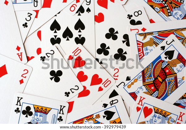 Play cards\
scattered on the table. Cards deck scattered. Play cards different\
colors. Play cards for bridge or poker (king, jack, queen...).\
Disarranged cards\
collection.