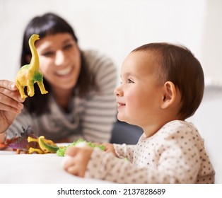 Play Date With Mom. Shot Of A Happy Mother Playing With Her Daughter And Toys.