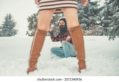 Play Girl And Man Snowball Fight In Snowy Forest. Christmas Couple Of Happy Man And Woman. Couple In Love In Winter