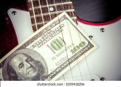 Play for money with guitar and cash. Music and money concept.