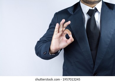 Play The Role Of Being An A Businessman With A Sign Of Okay On His Finger