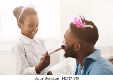 Play Together. Little Daughter Doing Makeup To Her Dad, Wearing Crowns