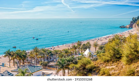 Playa Burriana at Nerja, Costa del Sol, Malaga. Very popular beach with tourists from all over. The beach has multiple restaurants and bars as well as souvenir shopping.
