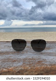 PLAYA DEL CARMEN-QUINTANA ROO-MEXICO-OCTOBER-2019: Maui Jim Sunglasses On Piece Of Wood Located On The Beach.