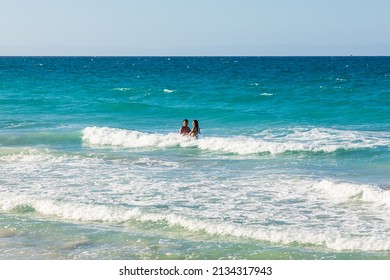 Playa El Tecolote, La Paz, Baja California Sur, Mexico. November 11, 2021. Couple In The Surf Near La Paz.