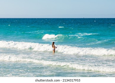 Playa El Tecolote, La Paz, Baja California Sur, Mexico. November 11, 2021. Woman In The Surf Near La Paz.