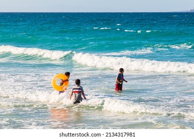 Playa El Tecolote, La Paz, Baja California Sur, Mexico. November 11, 2021. Boys Playing In The Surf Near La Paz.