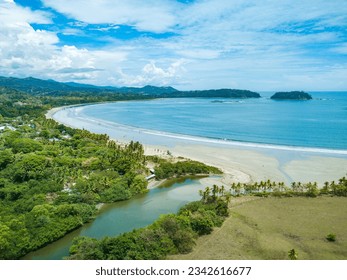 Playa Samara, Guanacaste, Costa Rica - Panoramic Aerial Drone view of the white sand Samara Beach overlooking its Estuary on the Pacific Coast of the Nicoya Peninsula