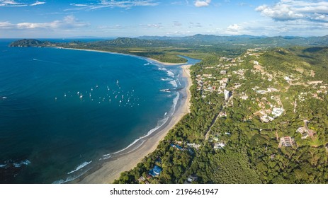 Playa Tamarindo, Guanacaste, Costa Rica - Aerial Drone shot, Panorama view of Tamarindo Beach and Playa Grande - most famous Surfer paradise, Party town, Tourism hotspot on the Pacific Coast - Shutterstock ID 2196461947