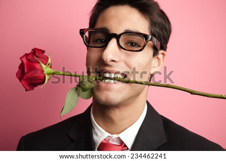 Playboy holding a rose with his teeth.