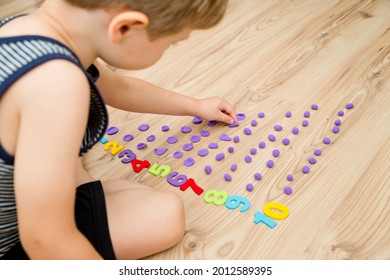 Play-Doh Stones And Numbers. Counting DIY Game. Mathematical Task. Play At Home. Way Of Learning. Kid Flatten Balls When Saying A Digit.